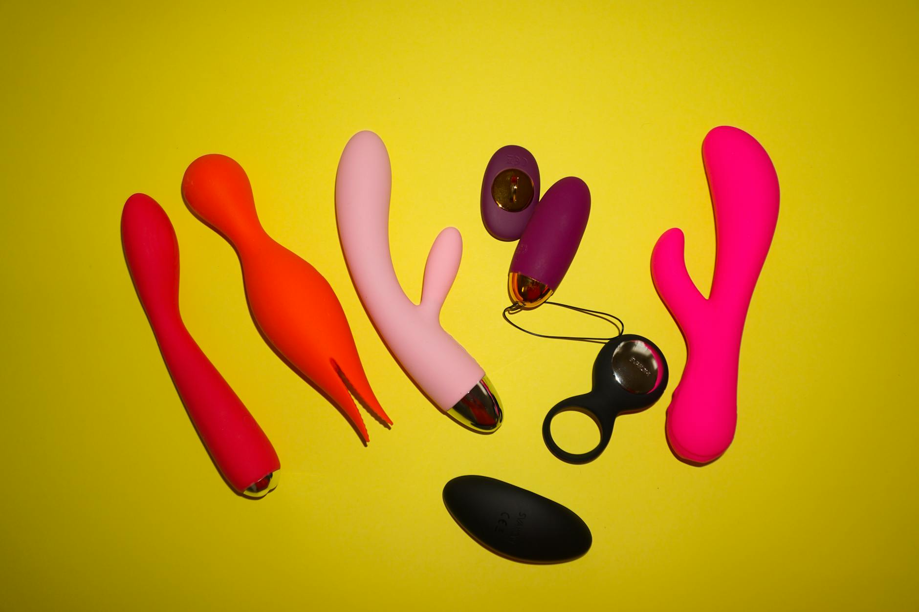 Colorful vibrators on a bright yellow background showcasing design variety